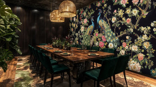 Ornate peacock wallpaper with floral branches in sophisticated dining room with emerald chairs and pendant lights