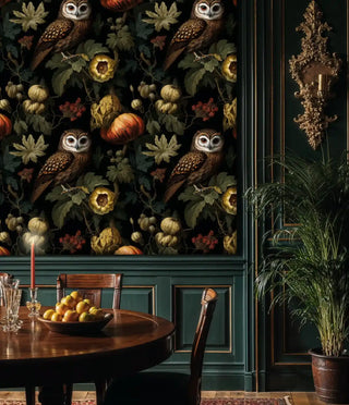 Owl botanical wallpaper, black and green with pumpkins, by green paneling and brass sconce
