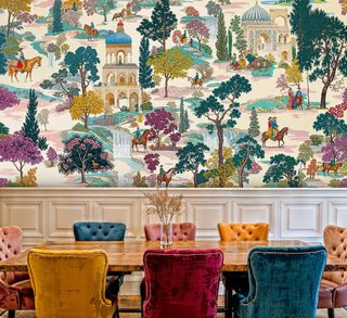 Palace garden mural with riders and domes in teal and beige, shown with velvet chairs