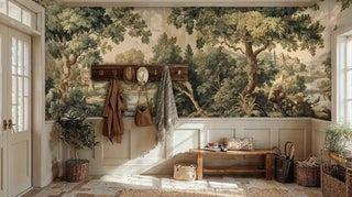 Pastoral countryside wall mural with trees and buildings, shown in bright entryway with wooden coat hooks