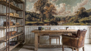 Pastoral landscape wall mural featuring rolling hills and trees in rustic office with leather chair