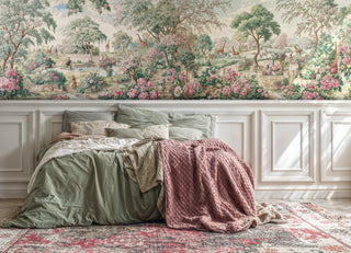 Pastoral rose garden wall mural with giraffes and stone steps, shown in a cozy bedroom with sage green bedding