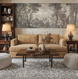 Pastoral scene wall mural featuring detailed foliage and classical buildings, displayed in sophisticated study with built-in bookshelves