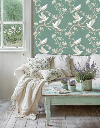Peaceful dove wallpaper with botanical elements, displayed in cottage living room with weathered coffee table