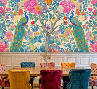 Peacock Garden Paradise Wall Mural with vibrant florals and peacocks, shown in elegant dining room with colorful velvet chairs