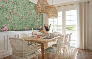 Peony garden wall mural with songbirds, shown in bright dining room with wicker pendant lights