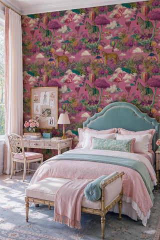 Pink fantasy animal wallpaper with zebras and balloons in a pastel bedroom with vintage writing desk