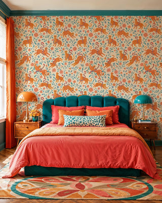 Playful leopard wallpaper with teal leaves and pink blooms, in a colorful bedroom with tufted teal headboard