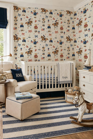 Preppy teddy bear wallpaper with sporty bears and sailboats in navy and red, in a nursery with white crib