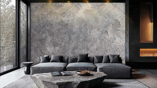 Raw concrete texture wallpaper featuring natural weathering patterns in grey, displayed in contemporary living space