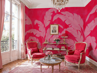 Red and pink banana leaf wall mural with bold tropical foliage in a Parisian living room with crystal chandelier