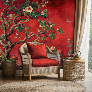 Red botanical wall mural featuring birds and flowering branches in reading nook with wicker chair