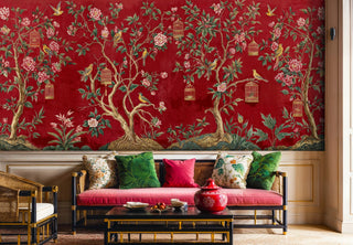 Red chinoiserie wallpaper with birds and flowers displayed in sophisticated living room with colorful pillows