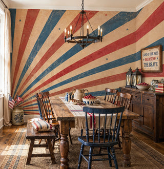 Retro sunburst wall mural in patriotic colors with stars in a farmhouse dining room with iron chandelier