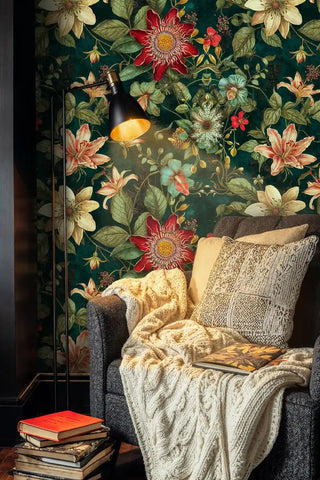 Rich passion flower wallpaper displaying coral blooms, shown in cozy reading corner with knitted throw blanket