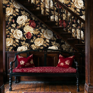 Romantic floral wallpaper with cream and red roses on black, shown in classic entryway with wooden staircase and bench