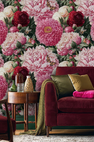 Romantic floral wallpaper with pink peonies and butterflies in sophisticated living room with burgundy velvet sofa