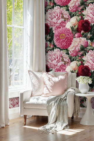 Romantic garden wallpaper with butterflies and peonies shown in bright reading nook with white armchair