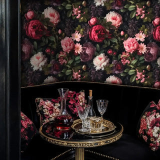 Romantic peony wallpaper with coral and burgundy blooms on black, shown in elegant bar with crystal decanter