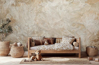 Rustic textured wallpaper in cream tones with natural variations, shown in kids room with wooden daybed