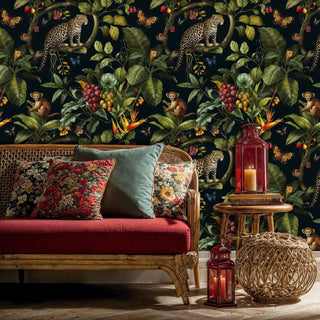 Safari animal wallpaper featuring leopards and tropical plants, displayed in living room with red velvet sofa