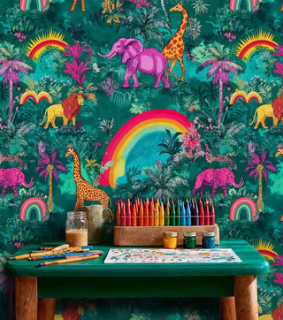 Safari animal wallpaper featuring pink elephants and bright rainbows, displayed in creative space with art supplies