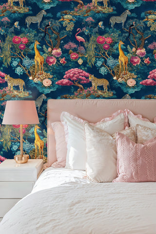 Safari botanical wall mural with exotic wildlife and blooms in teal and pink, featured in serene bedroom with soft pink bedding