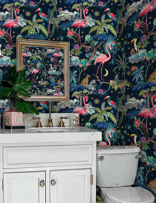 Safari paradise wallpaper with flamingos and exotic animals on dark background, displayed in powder room with white vanity