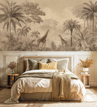 Safari scene wall mural featuring giraffes and palms, shown in serene bedroom with woven headboard and neutral bedding
