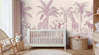 Safari themed wallpaper with pink elephants and palm fronds displayed in modern nursery with white crib and natural wood furniture