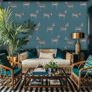 Safari zebra pattern wallpaper on teal background, shown in tropical living room with rattan furniture