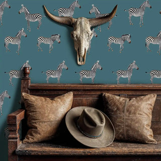 Safari zebra wallpaper with black and white stripes on teal background, displayed in rustic bedroom with bull skull