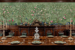Sage green chinoiserie wall mural with pink flowers and blue birds, featured in formal dining room with candelabras
