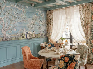 Scenic Asian wall mural featuring blooming trees and birds in cozy dining nook with floral curtains