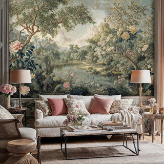 Scenic garden wallpaper featuring herons and blooms in sage and coral, shown in cozy living room with floral pillows