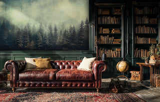 Serene forest wallpaper featuring misty evergreens in classic library with vintage globe and leather sofa