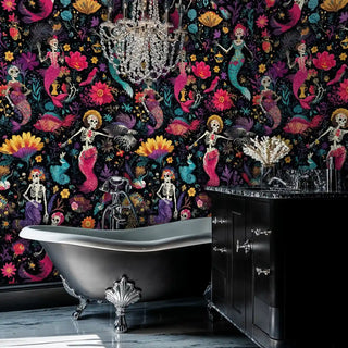 Skeleton mermaid wallpaper with tropical fish and flowers, shown in luxury bathroom with crystal chandelier and clawfoot tub