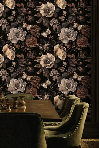 Sophisticated butterfly botanical wallpaper in sepia tones, shown in dining room with green velvet chairs