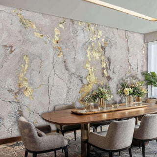 Sophisticated dining room with an abstract gold concrete wall mural, styled with an oval wooden table and grey chairs.