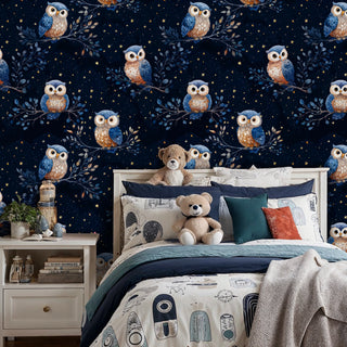 Starry night owl wallpaper with blue and amber owls on branches, shown in child's bedroom with teddy bears
