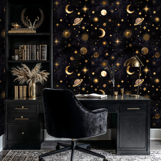 Starry night wallpaper with golden celestial elements displayed in sophisticated home office with black desk