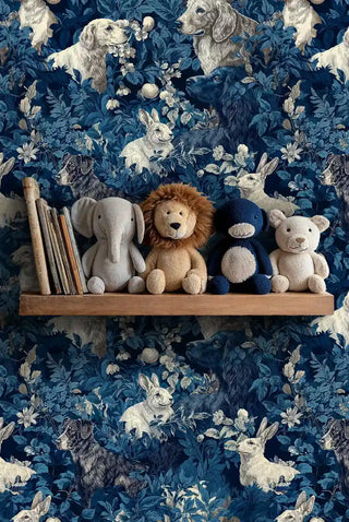 Storybook animals wallpaper in navy and cream, displayed in nursery with wooden cradle and teddy bears