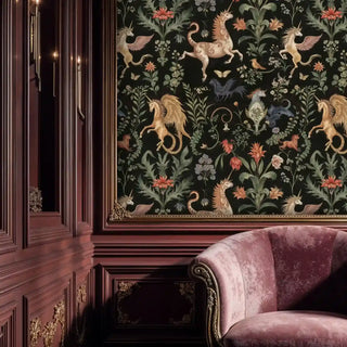 tapestry-style unicorn wallpaper with gold figures and floral vines on black, shown within an ornate framed wall and pink velvet chair