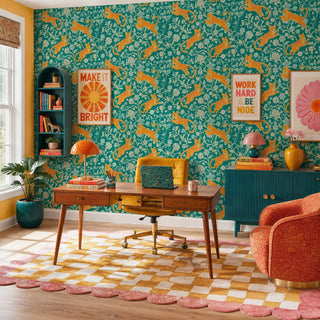 Teal and orange leopard floral wall mural in a colorful home office with mid-century wooden desk