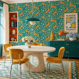Teal leopard floral wall mural with golden big cats and botanical vines in a vibrant dining room with round table