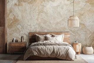 Textured beige wall mural with handcrafted plaster effect, styled in rustic bedroom with wooden furniture