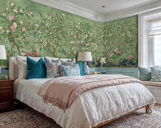 Traditional botanical wallpaper displaying flowering trees and stone formations, in serene bedroom with teal pillows