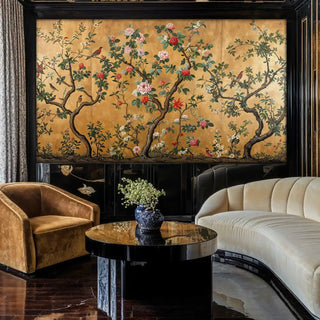 Traditional chinoiserie wallpaper with birds and blossoms, featured in sophisticated living room with curved sofa