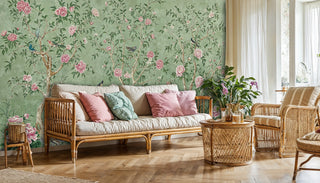 Traditional chinoiserie wallpaper with blooming branches, displayed in cozy living room with rattan furniture
