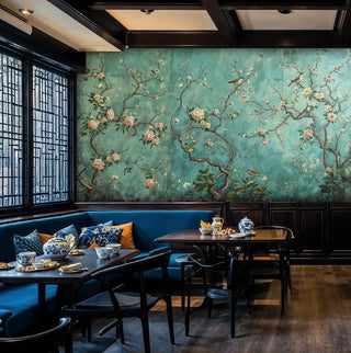 Traditional chinoiserie wallpaper with flowering branches, shown in sophisticated dining nook with banquette seating